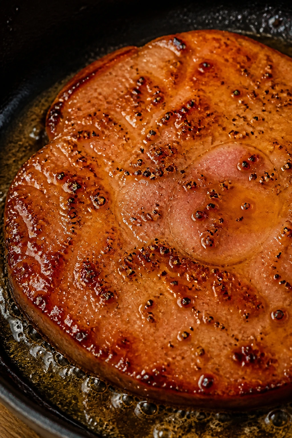 Ham steak with brown sugar Dijon glaze in a skillet