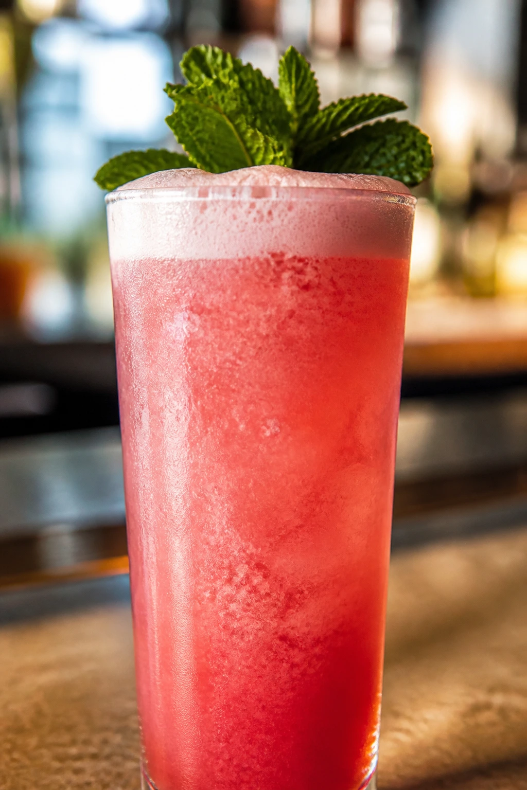Hibiscus Rum Fizz close-up with pink foam and mint