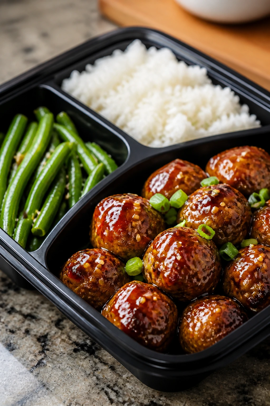 Close-up of honey-sesame turkey meatball meal prep box with rice and green beans
