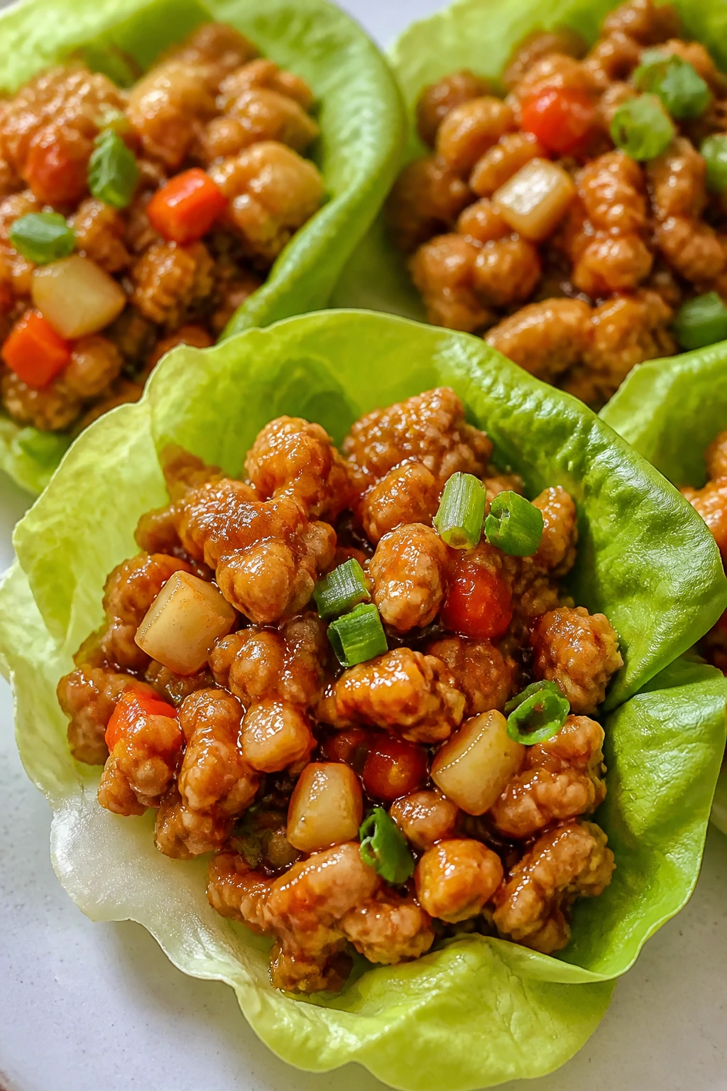 Lettuce cups filled with honey-sriracha chicken
