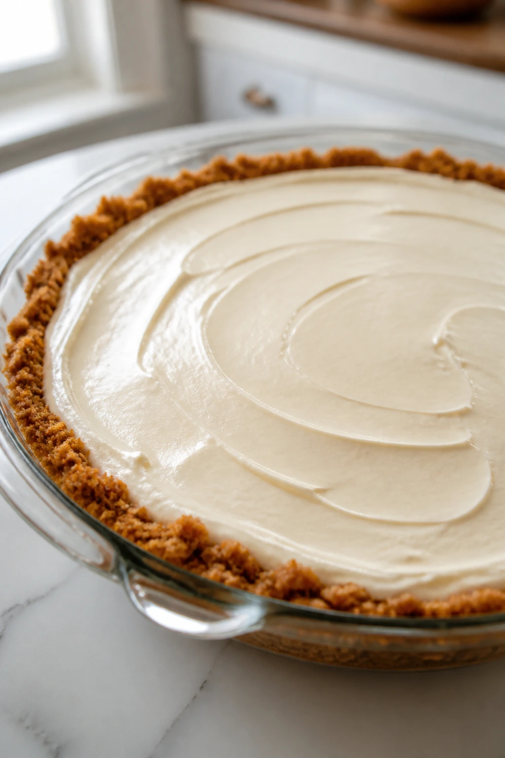 Icebox pie in a glass dish on a kitchen counter