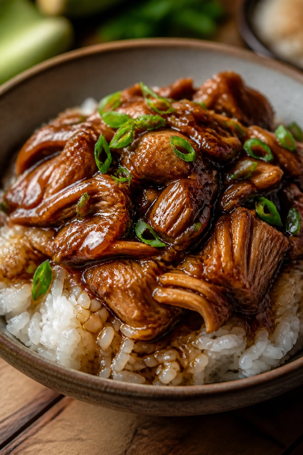 Jackfruit over rice with glossy glaze in a rustic bowl