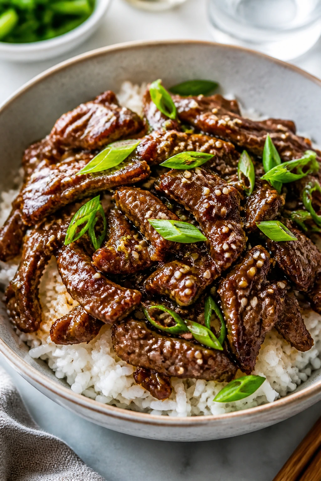 Korean beef bowl over rice with sesame and scallions