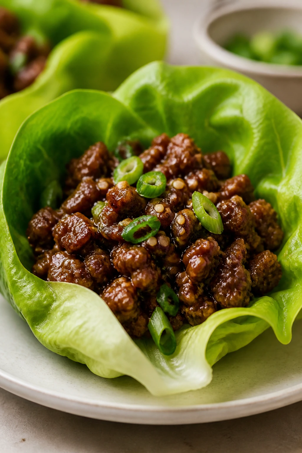 Close-up of a single beef lettuce cup with sesame seeds
