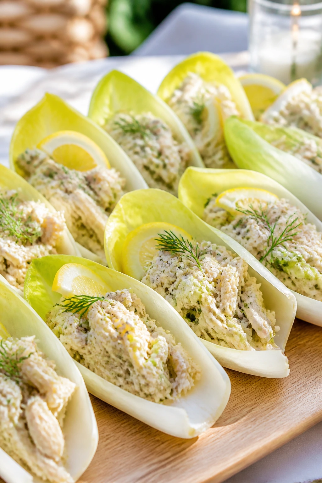 Close-up of endive cups filled with lemon-herb chicken salad on a platter