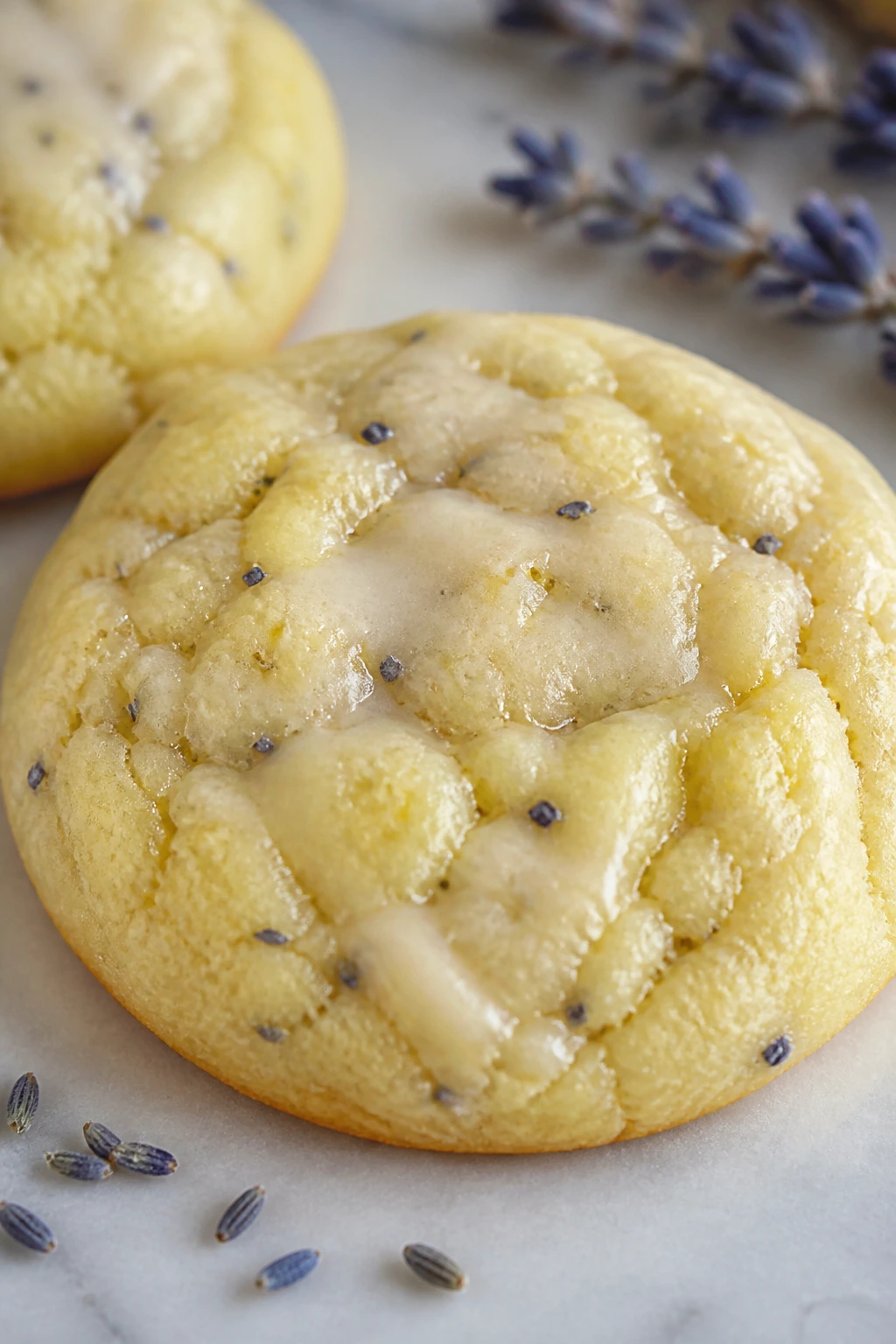Close-up of pale lemon-lavender cookie with lavender specks.