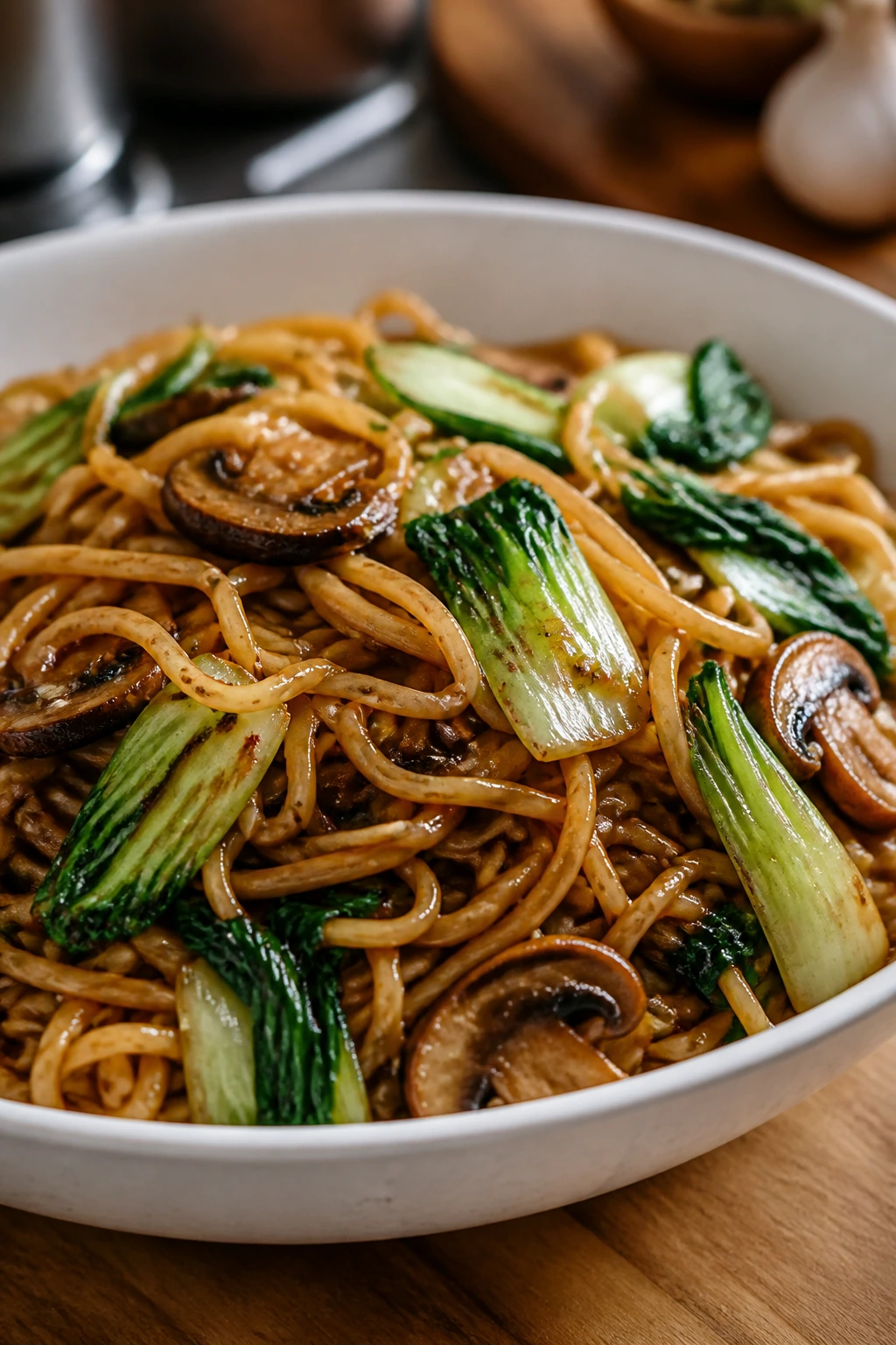 Saucy garlic sesame lo mein with mushrooms and bok choy in a bowl