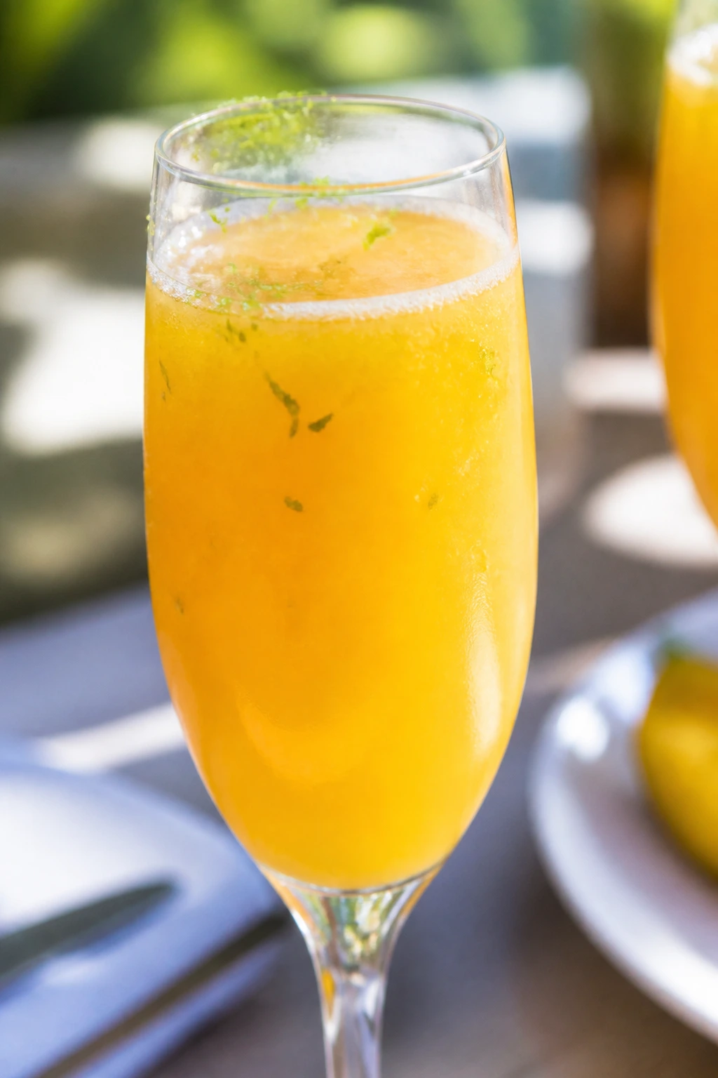 Close-up of a champagne flute filled with mango mimosa and mango nectar