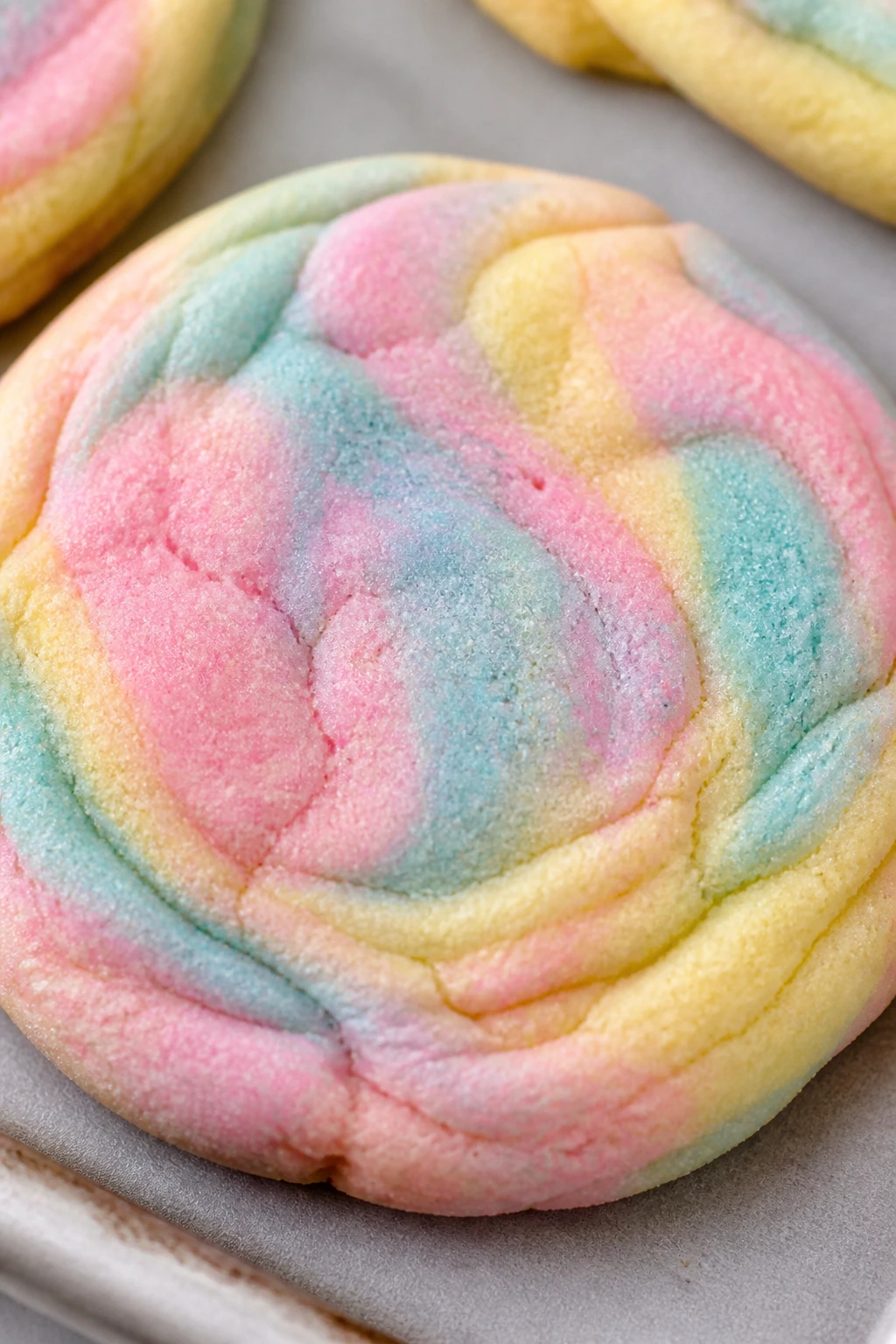 Close-up marbled pastel rainbow cookie with pastel swirls