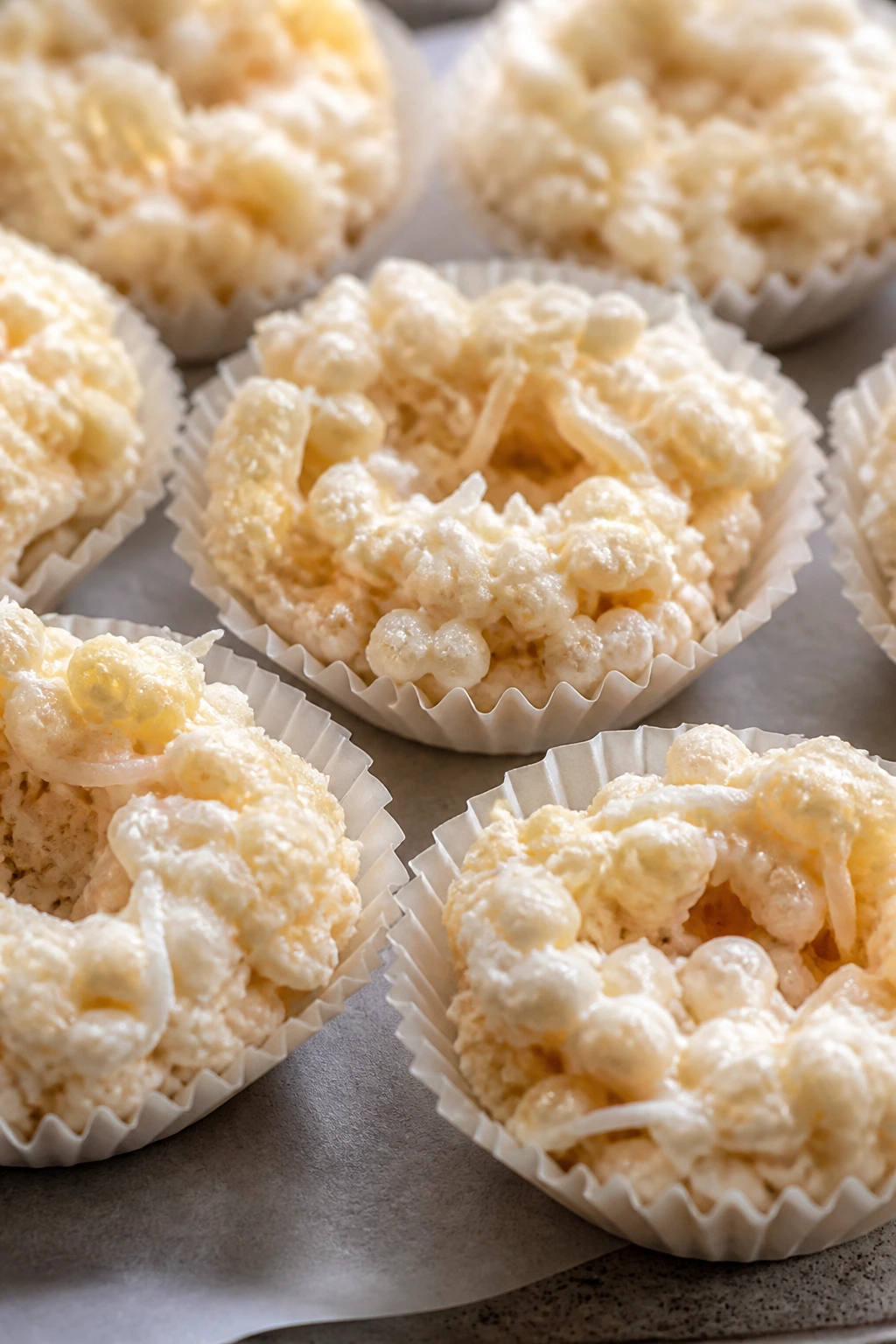Close-up of marshmallow coconut nests in muffin cups on parchment