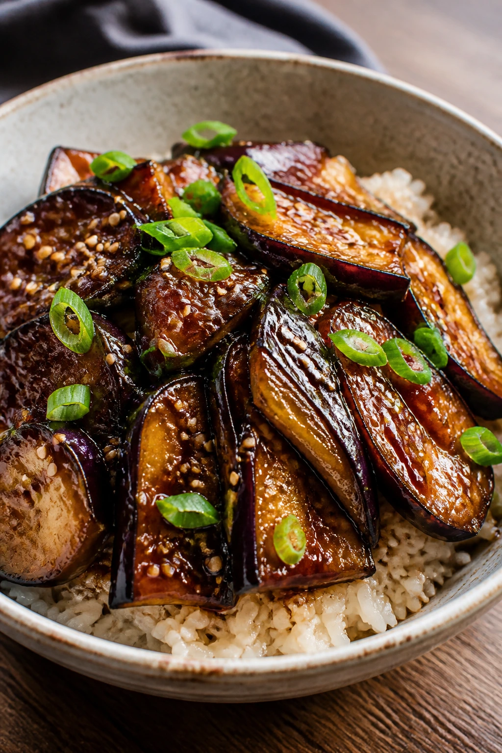 Miso-glazed eggplant over rice in a bowl