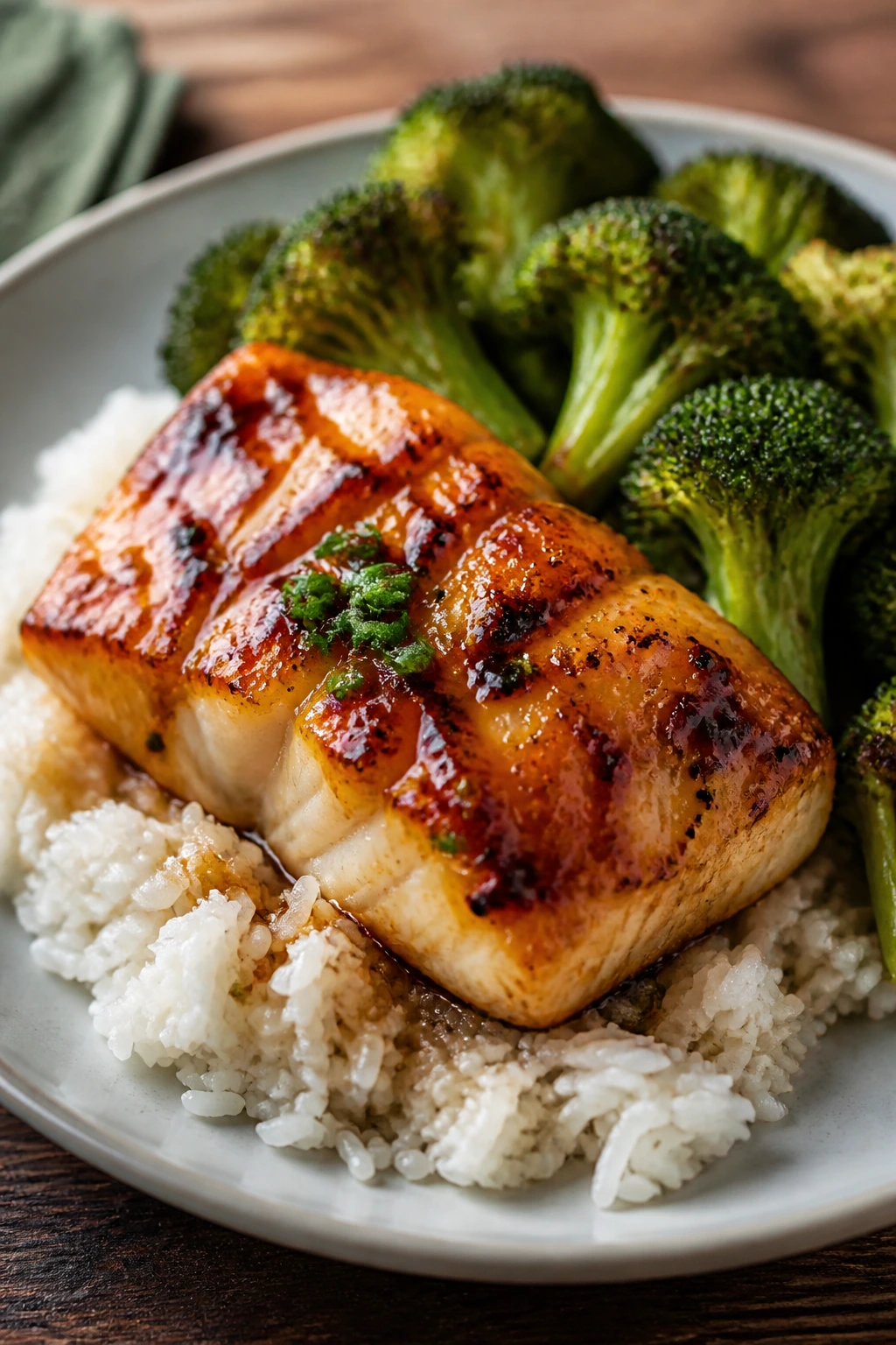 Close-up of miso glazed cod with broccoli and rice on a plate