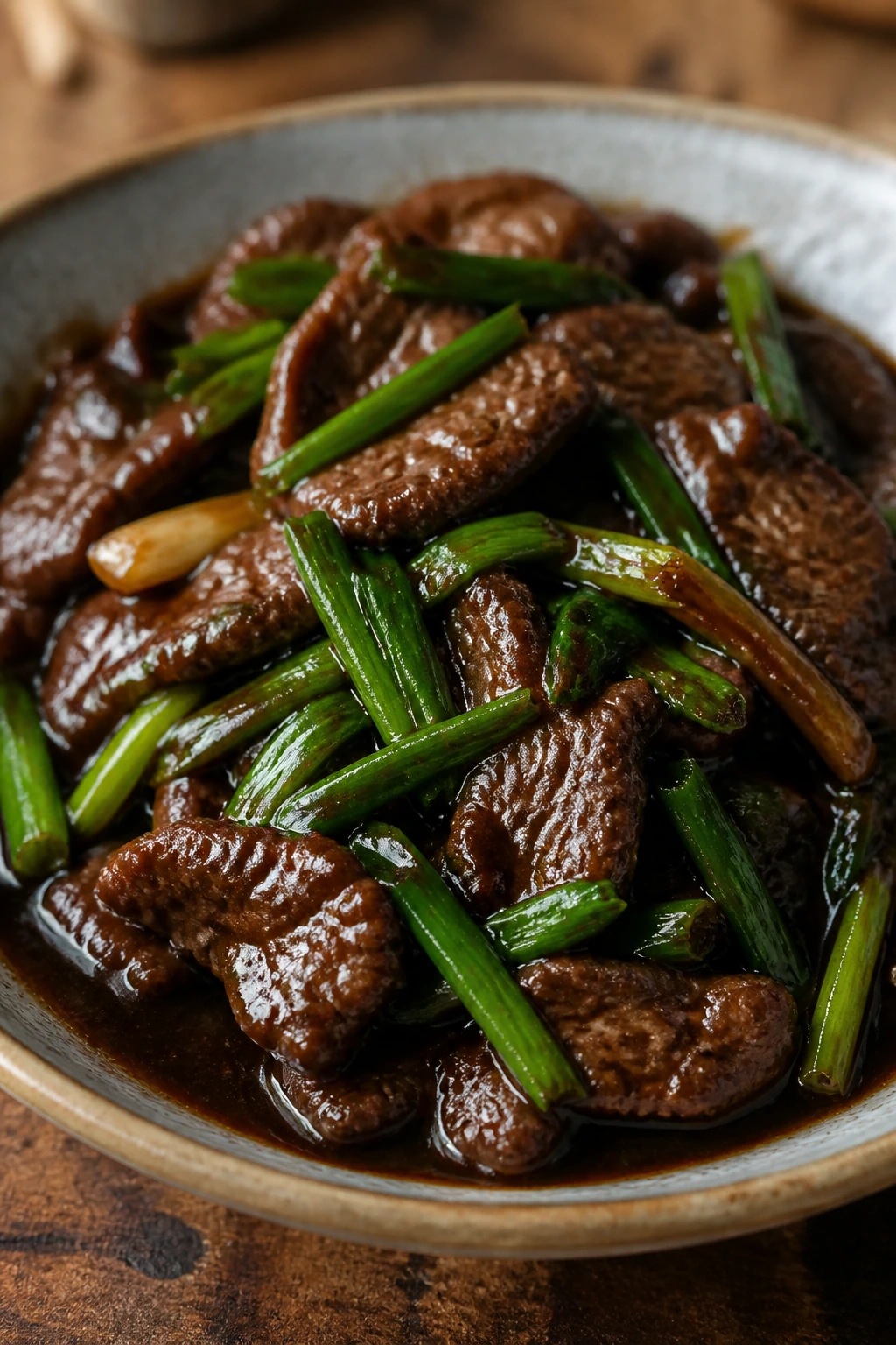 Beef in glossy Mongolian sauce with scallions in a bowl