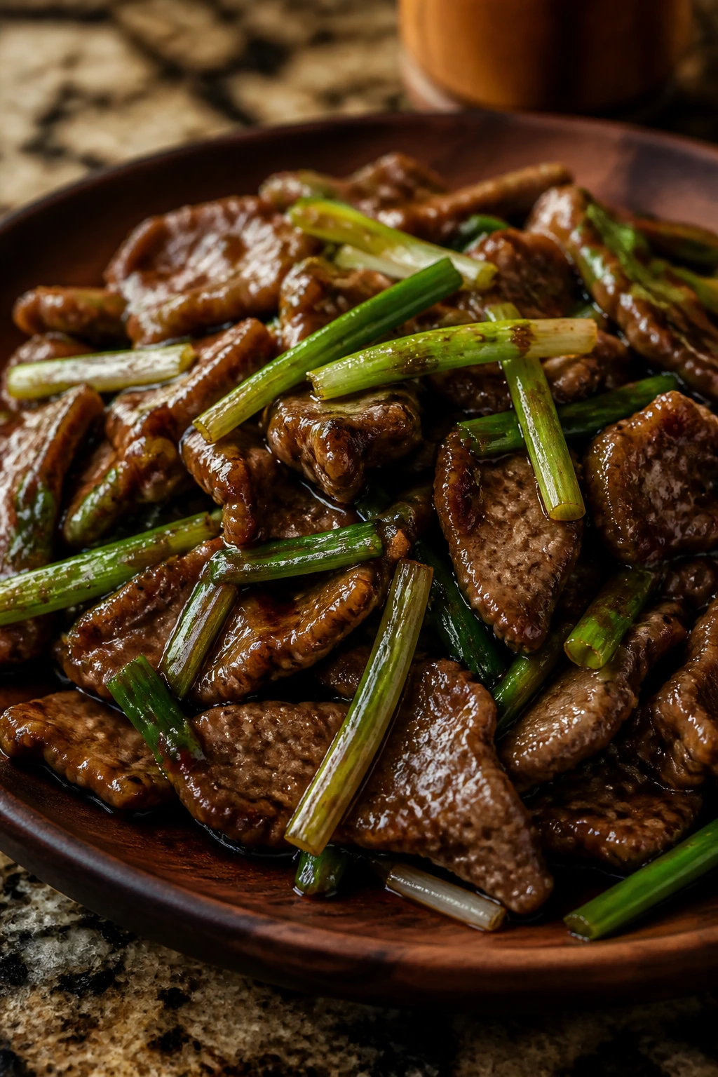 Close-up of Mongolian beef with scallions in glossy sauce
