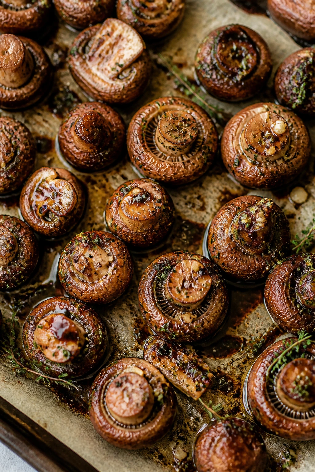 Close-up of herb-roasted mushrooms with garlic and thyme in a home kitchen
