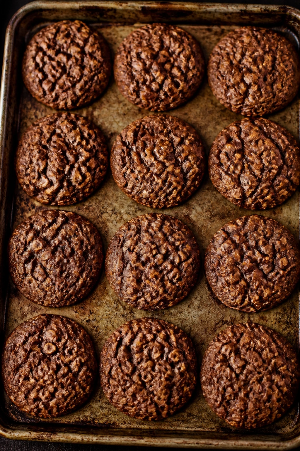 Tray of chocolate oatmeal cookies on baking sheet filling the frame