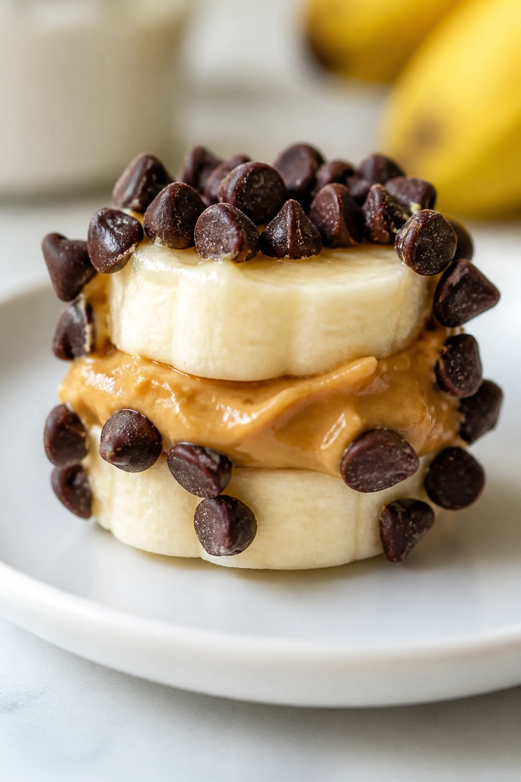 Close-up of peanut butter banana bites on a small plate in a bright kitchen