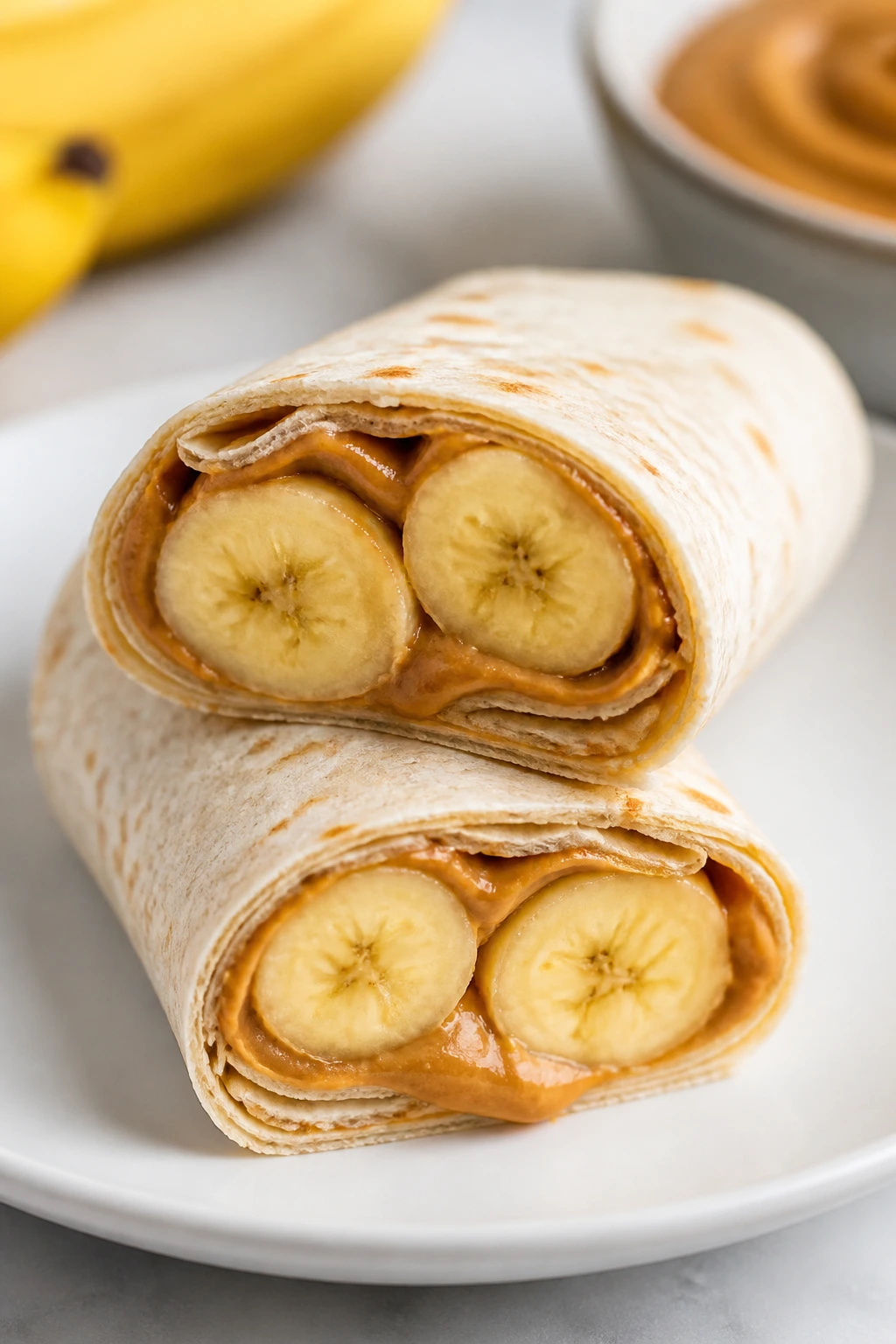 Close-up of peanut butter banana wrap showing filling on a plate