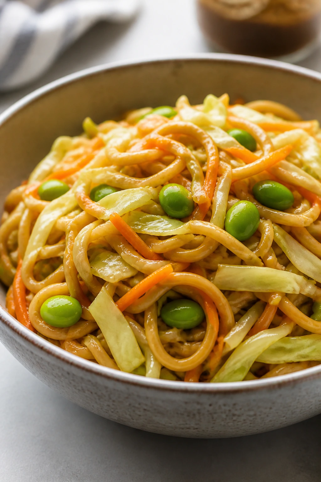 Close-up of peanut noodles with cabbage in a bowl