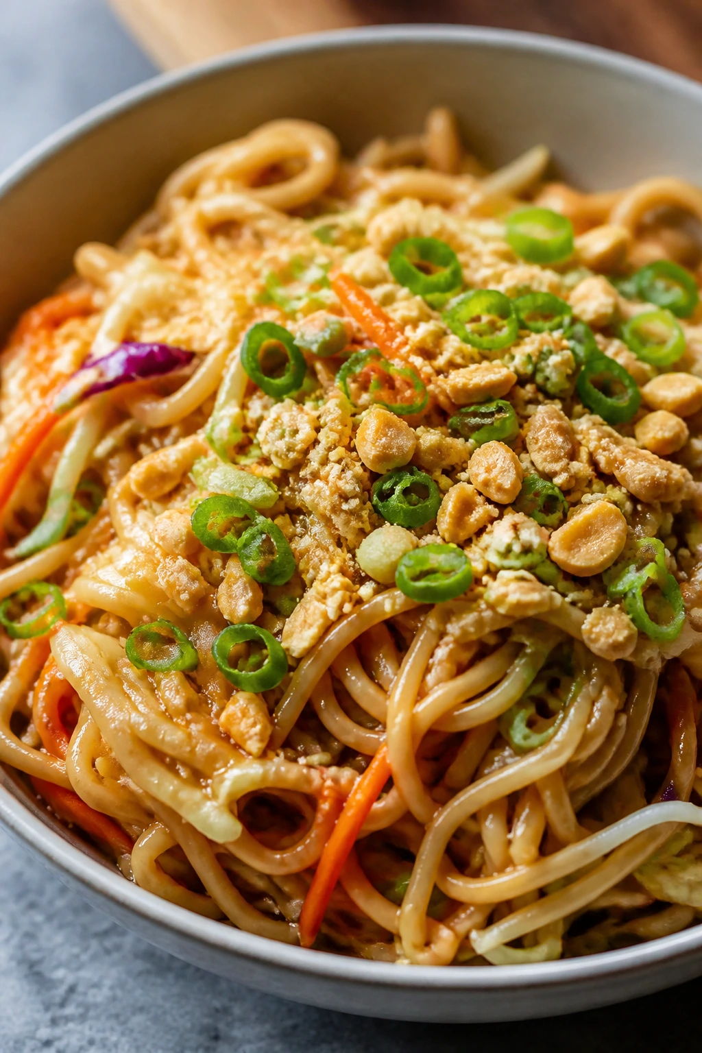 Peanut noodles with veggies in a colorful bowl
