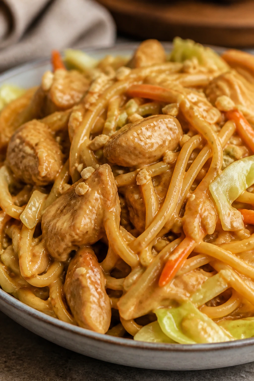 Close-up of Peanut Sesame Chicken Noodles with chicken and noodles in a peanut sauce.