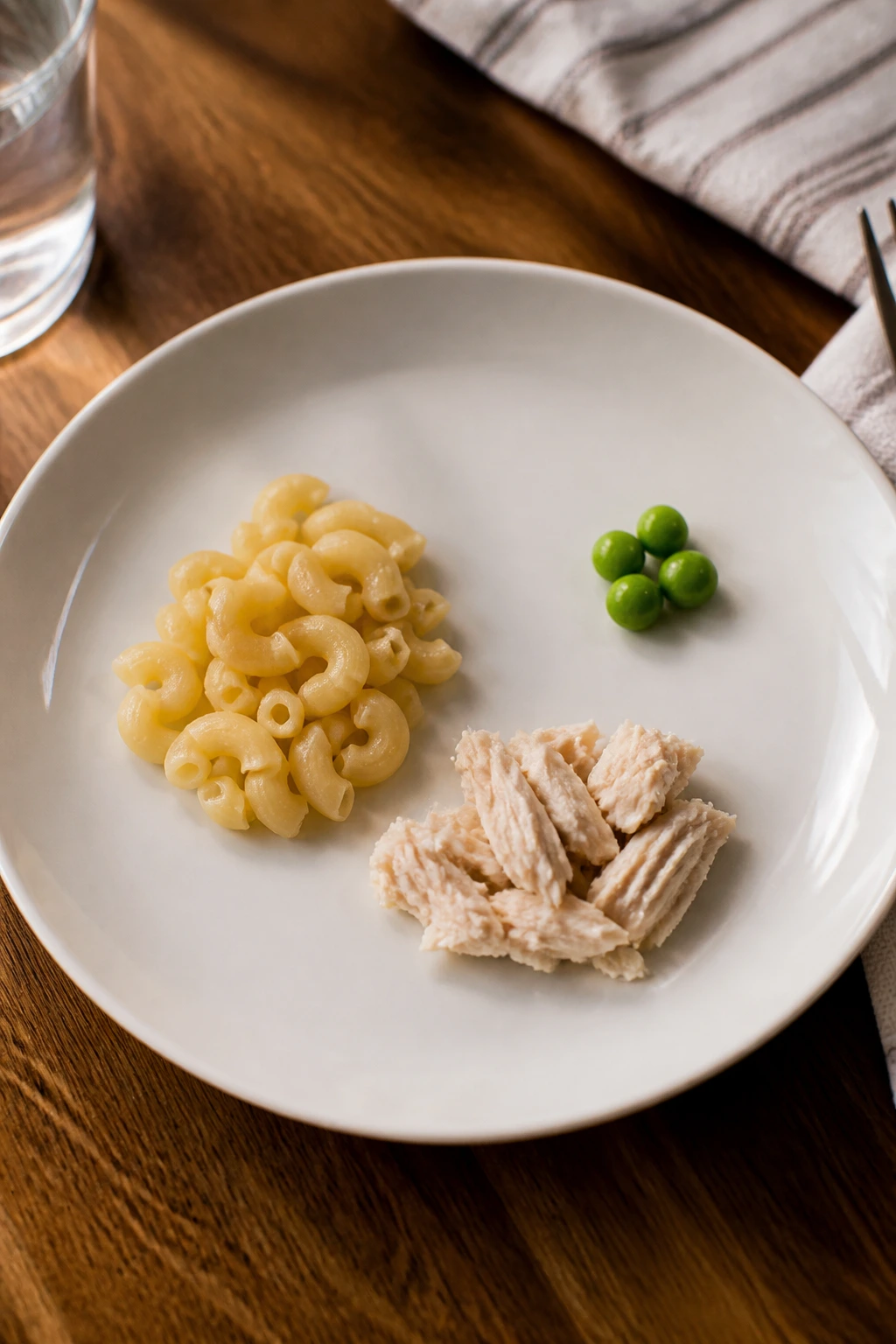 Close-up plate showing a one-safe-food plate with starch, protein, and tiny new item for picky eaters.