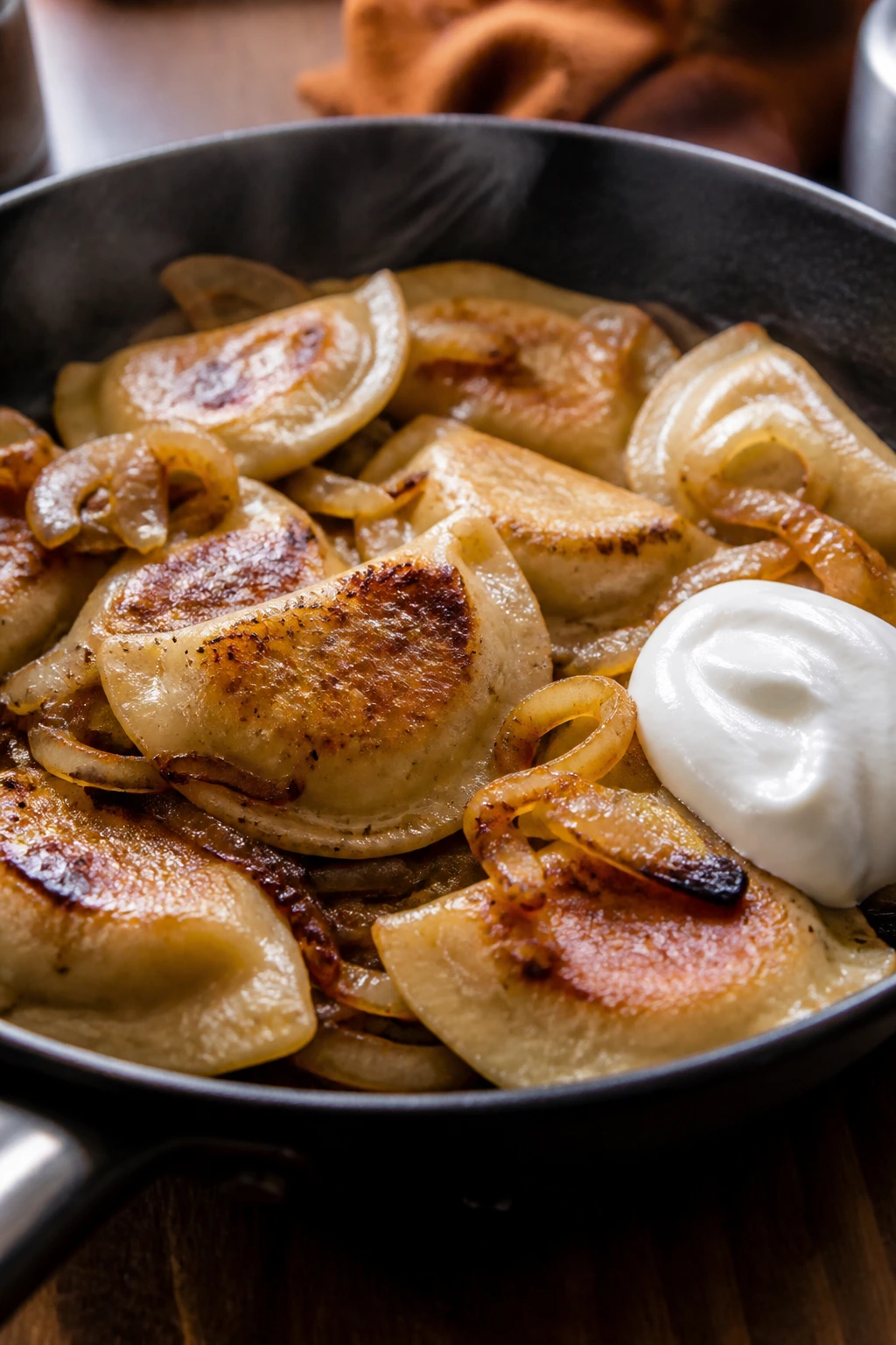 Pierogi skillet with onions and sour cream in a cozy kitchen