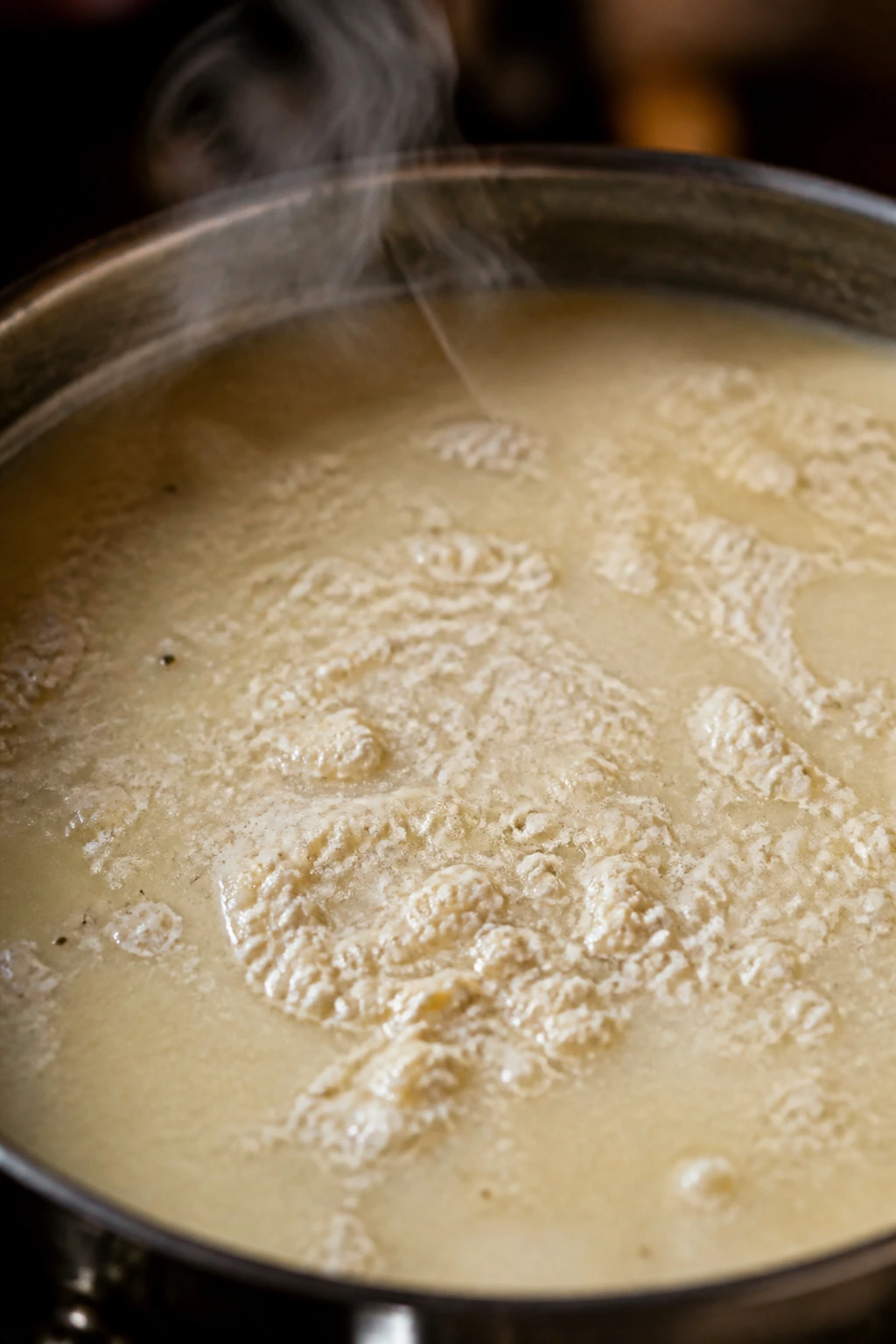 Pot of creamy potato soup with slightly curdled surface indicating chalky texture
