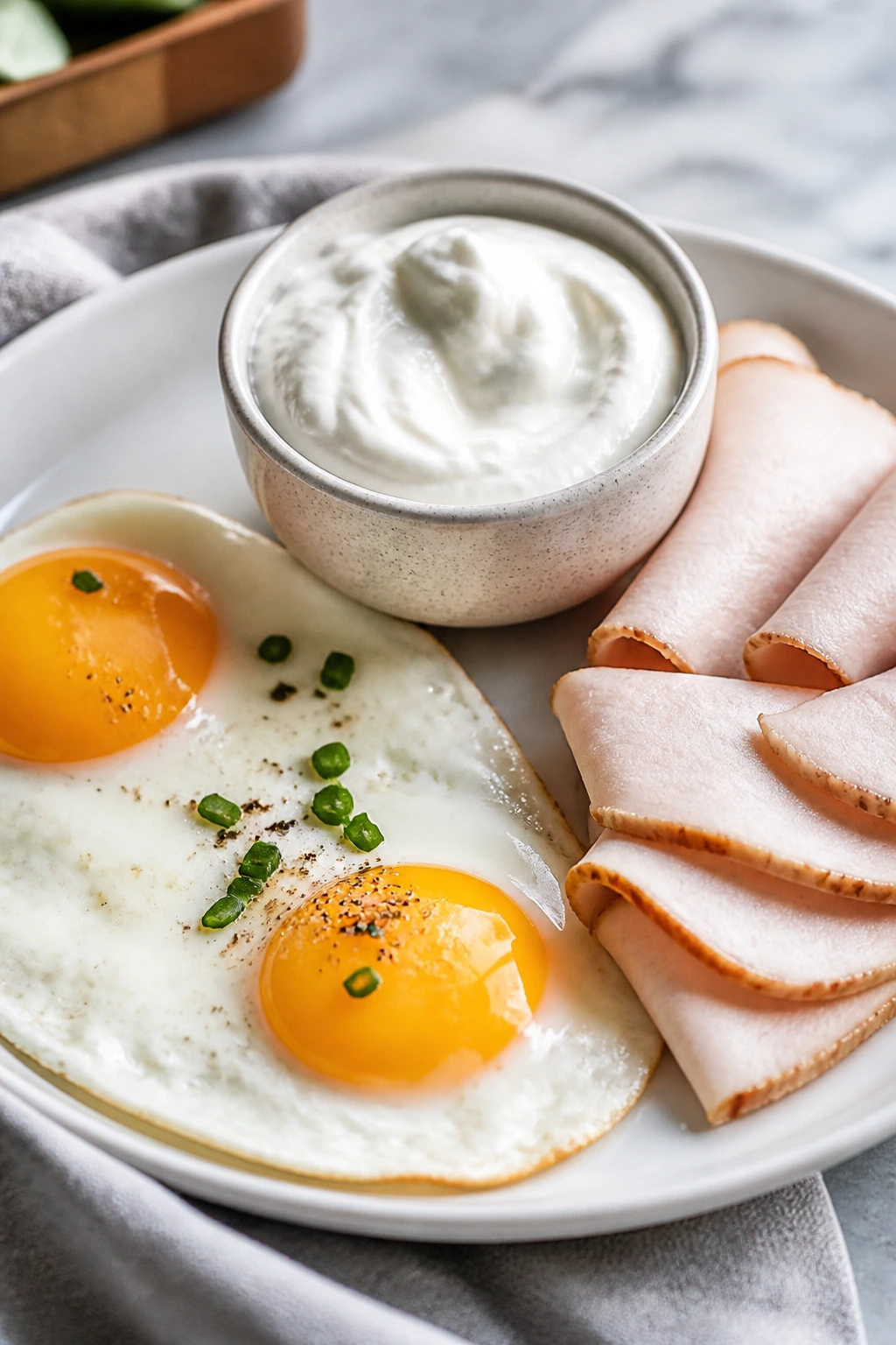 Plate with eggs, turkey, and yogurt emphasizing protein anchor for a meal