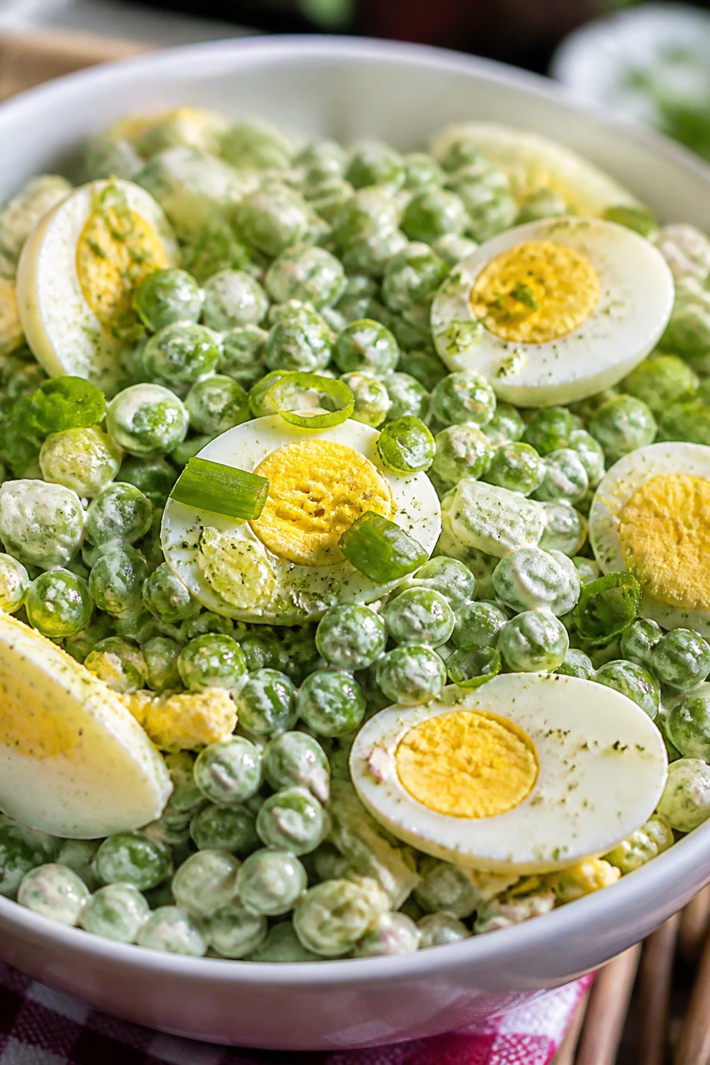 Close-up of Ranch Pea Salad with eggs and scallions in ranch dressing