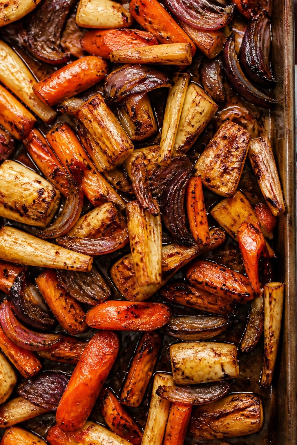 Roasted root vegetables with balsamic glaze on a sheet pan