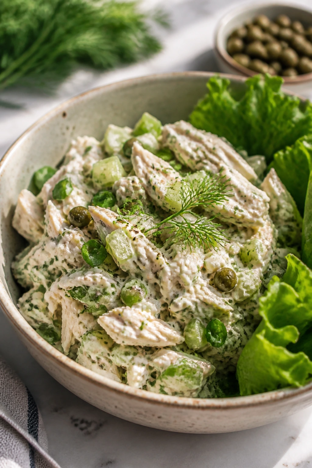 Close-up of a fresh chicken salad bowl with dill and celery