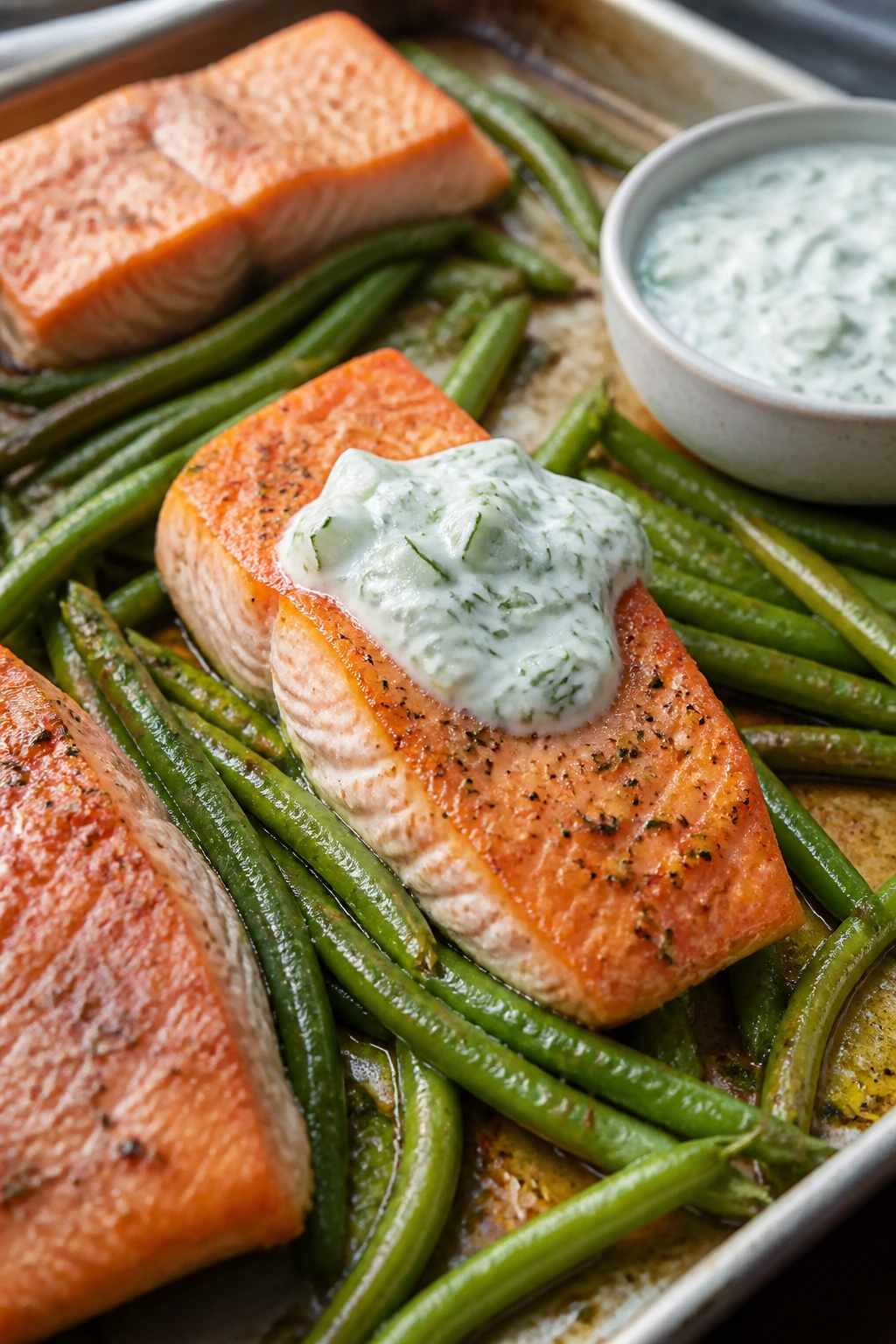 Close-up of salmon fillet with green beans and cucumber dill yogurt