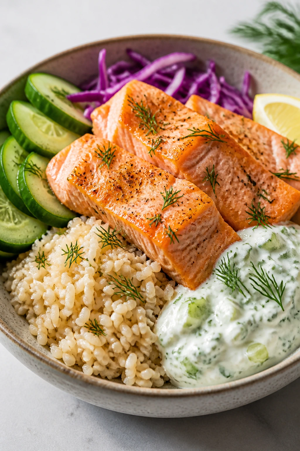 Salmon rice bowl with cucumber-dill yogurt topping