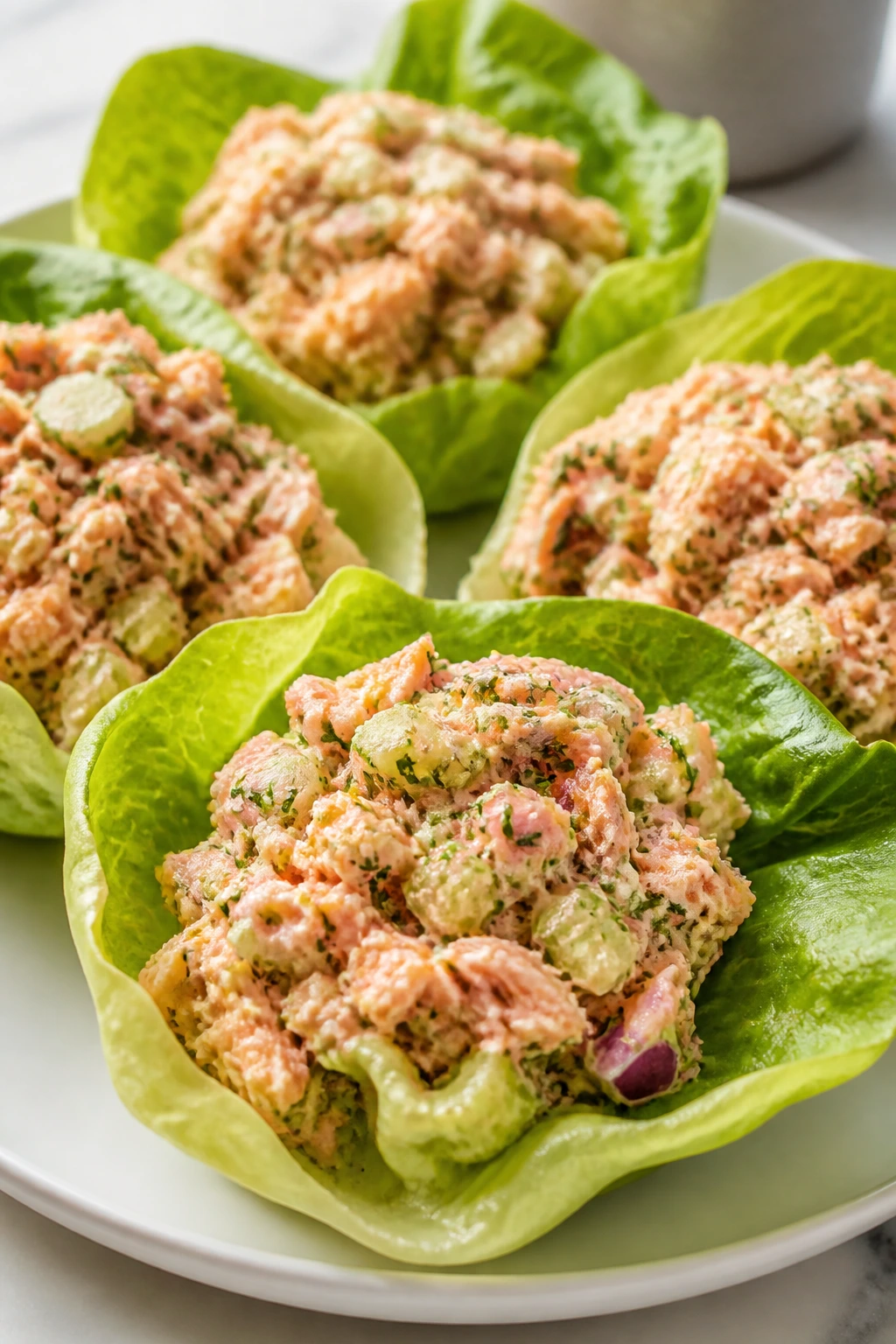 Close-up of salmon salad lettuce cups on a plate