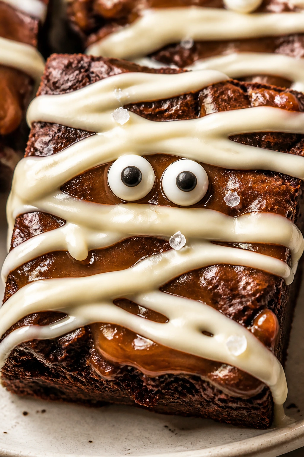 Brownie with caramel swirls and salt on a plate