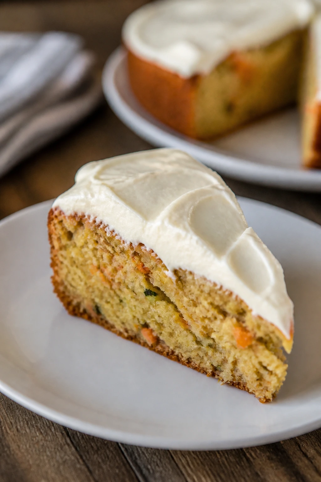 Single slice of savory pie with cream cheese frosting on plate