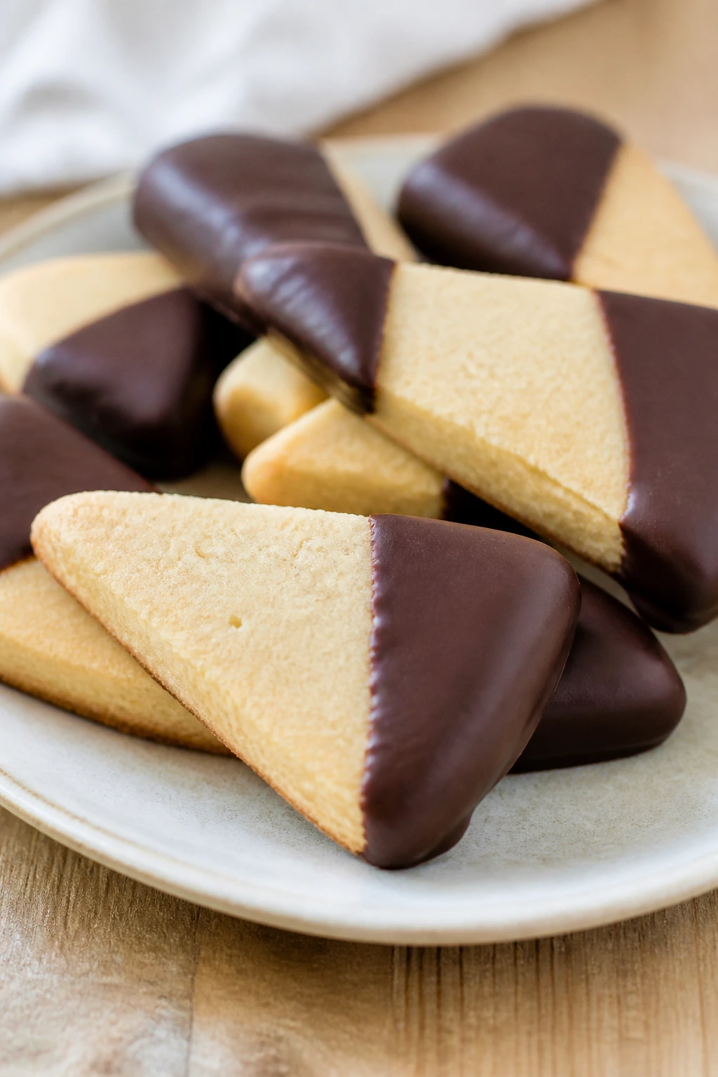 Chocolate-dipped shortbread wedges on a plate