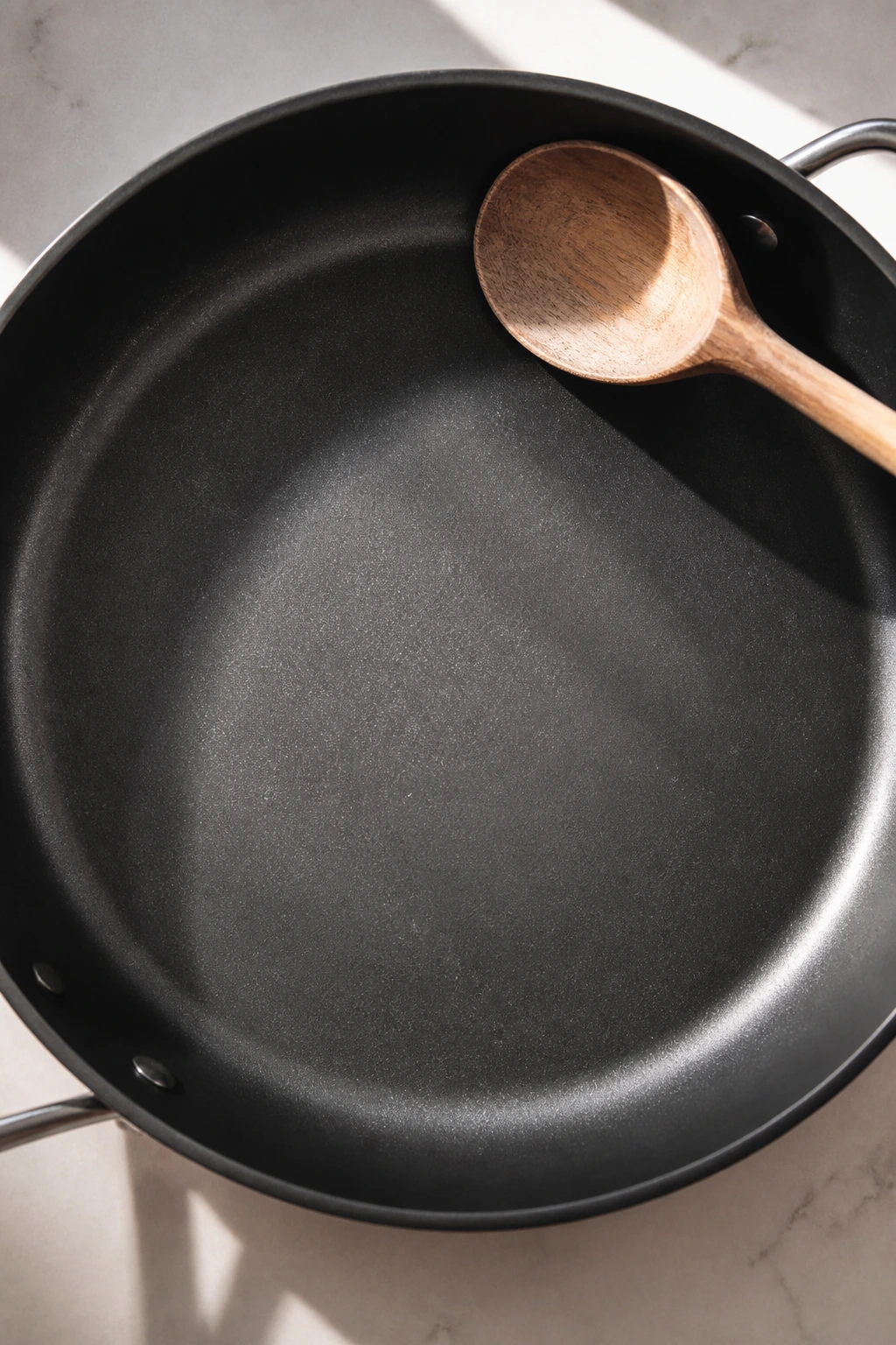 12-inch skillet with wooden spoon on kitchen counter