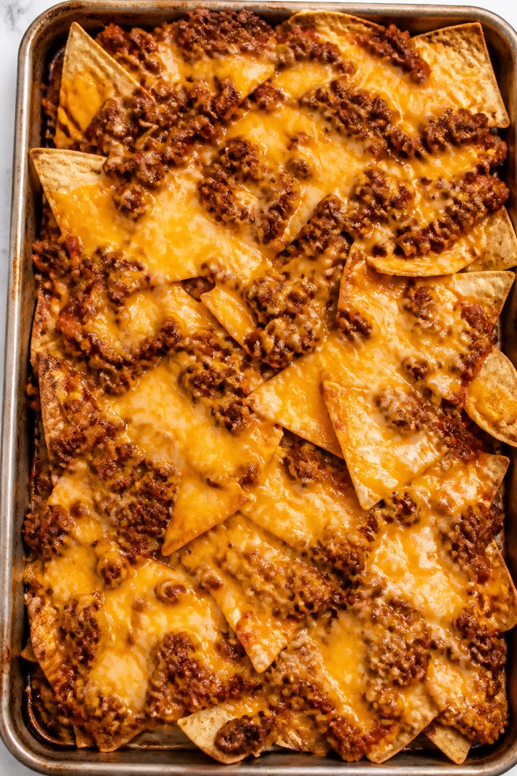 Close-up of sloppy Joe nachos on a sheet pan