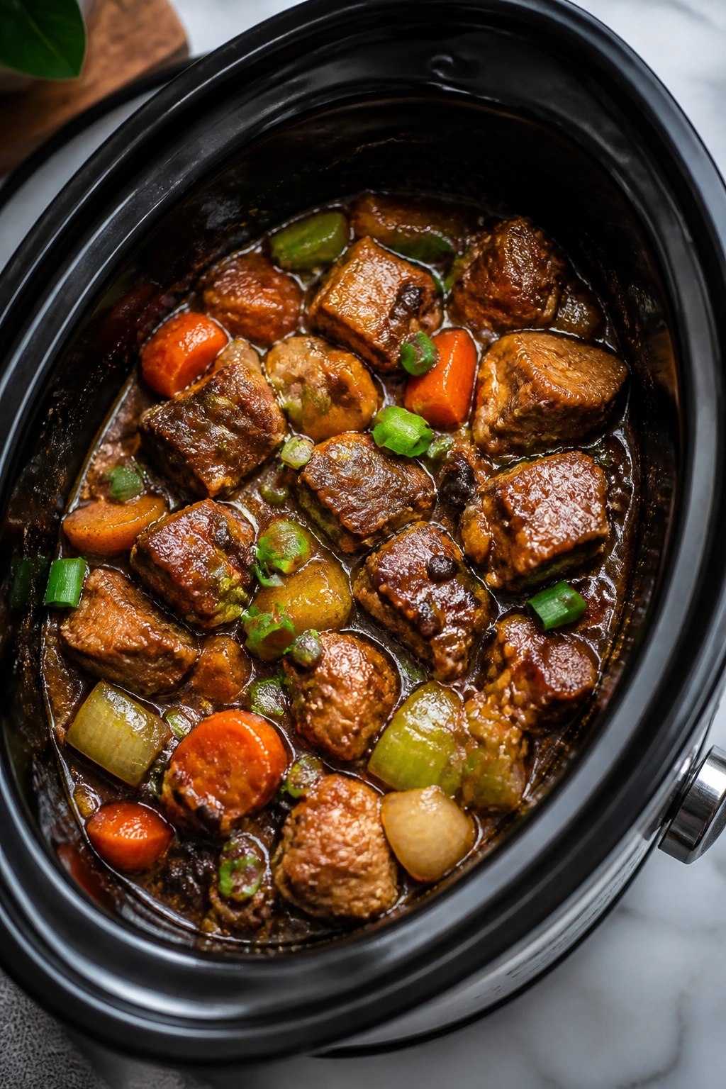 Braised Chinese dish in slow cooker insert showing glaze