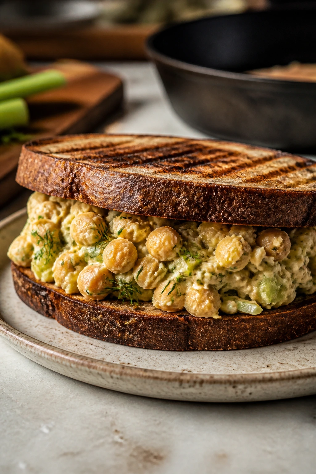 Close-up of Smashed Chickpea Salad Sandwich on grilled rye bread.