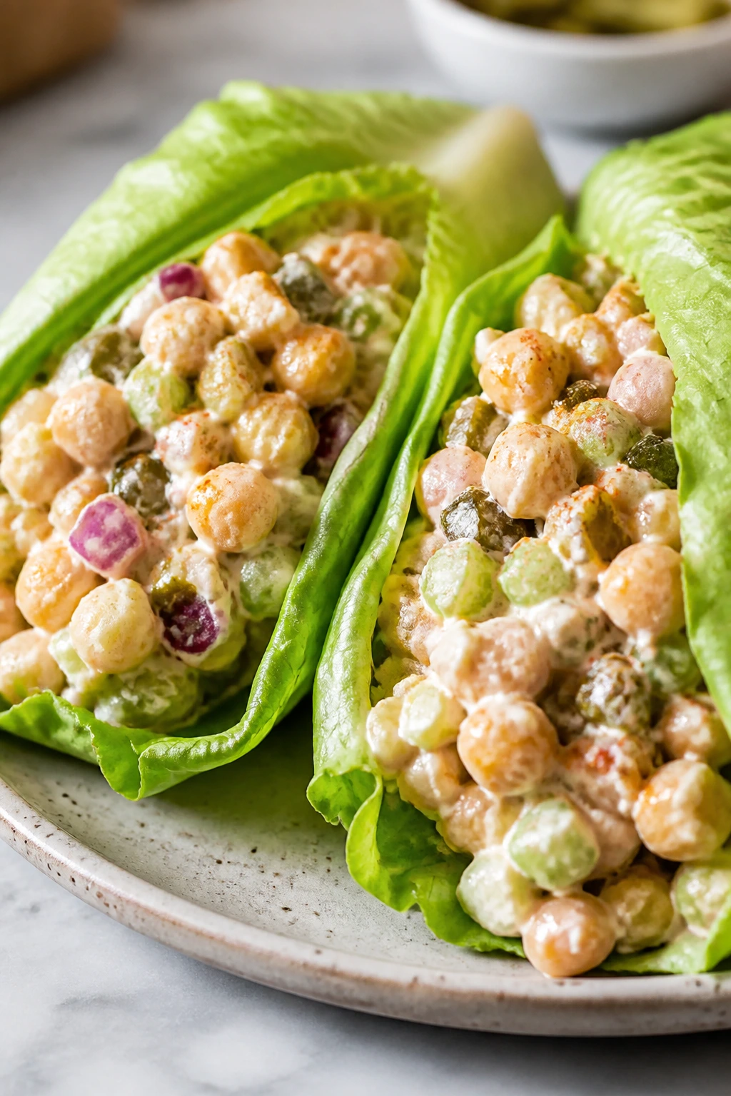 Two lettuce wraps filled with smoky chickpea salad