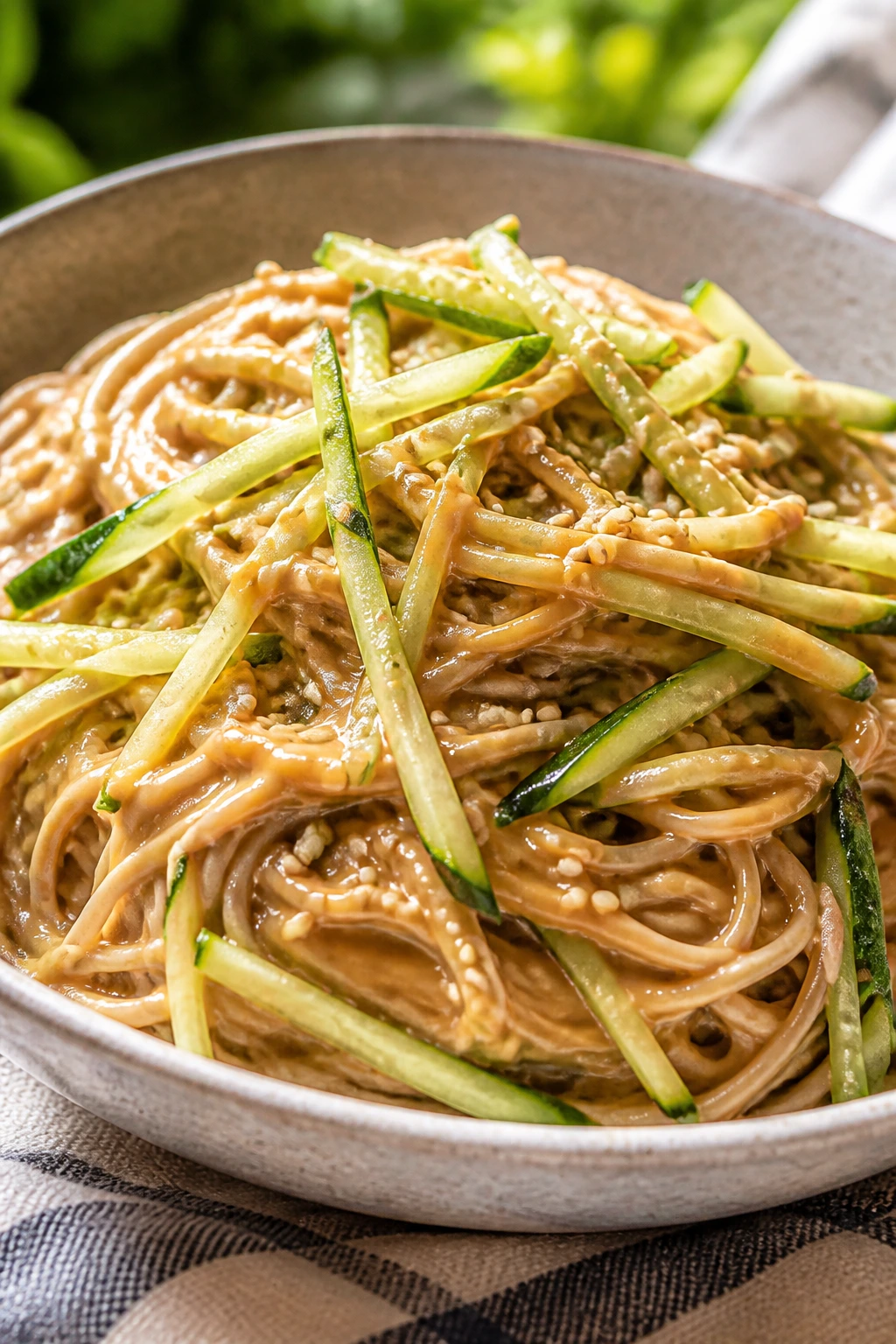 Close-up of cold peanut soba noodles with cucumber and sesame seeds