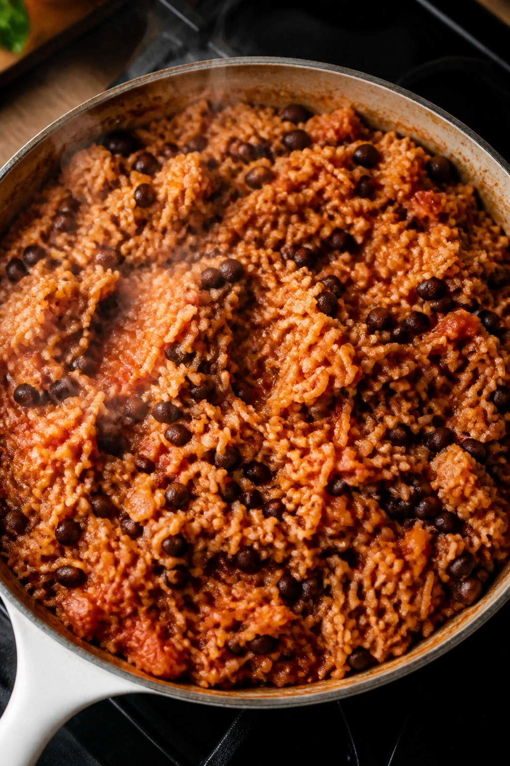 Pan of Spanish rice and beans with tomato and cumin