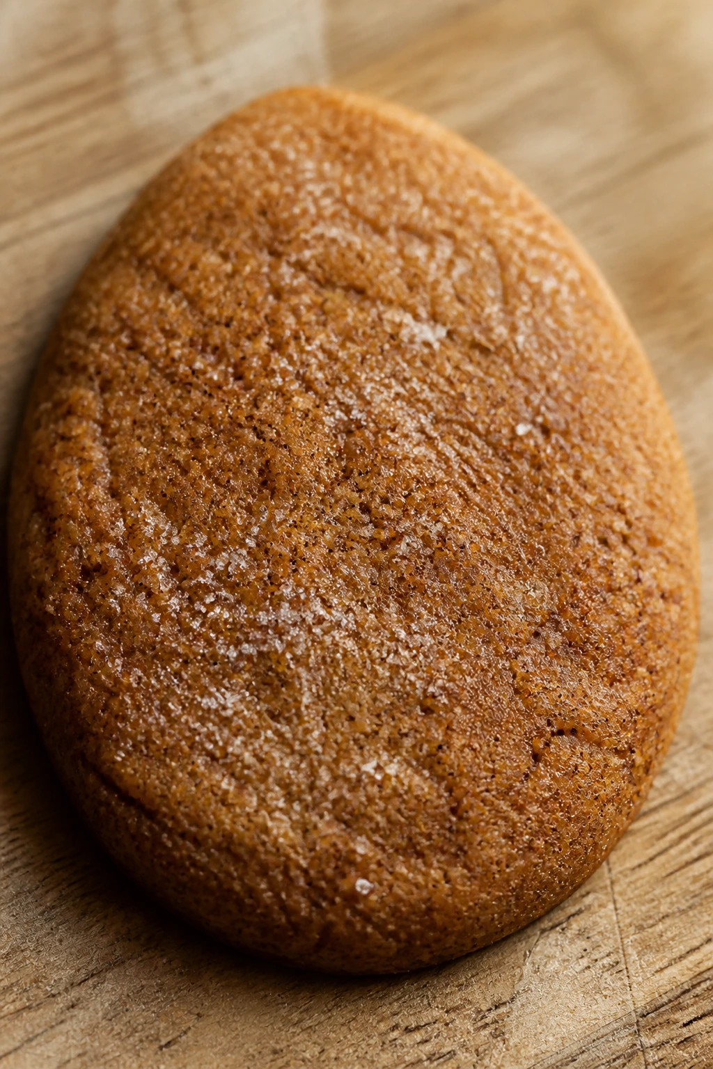 Close-up of a spiced egg-shaped cookie on a wood surface