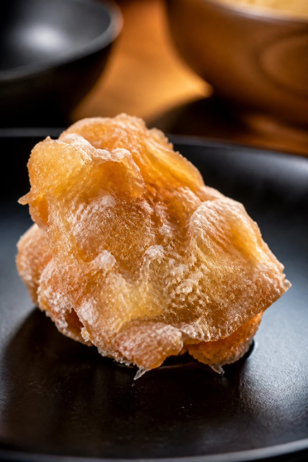 Close-up of a chicken piece with a thin, shattery starch crust.