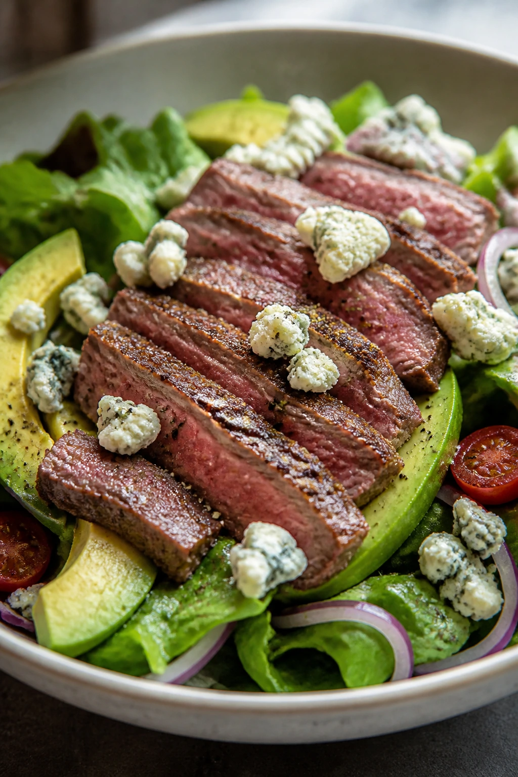 Close-up steak salad with avocado and blue cheese
