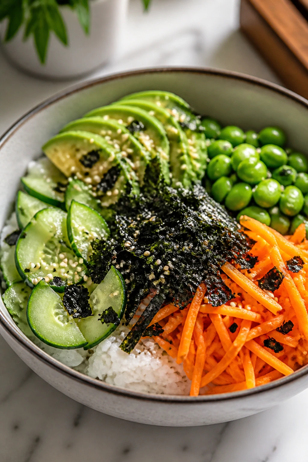 Close-up of a rainbow sushi bowl with avocado, cucumber, and edamame