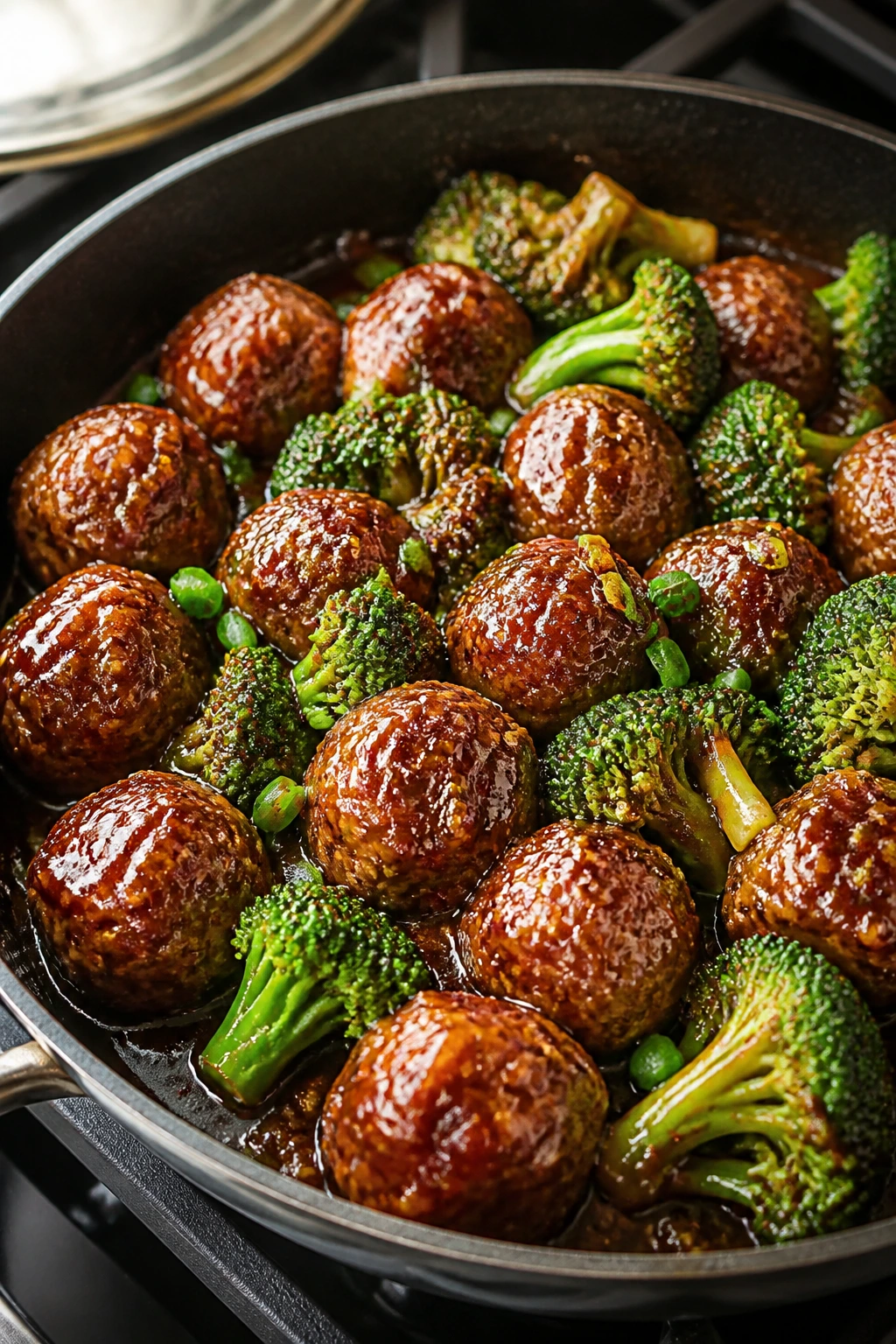 Skillet with glossy teriyaki meatballs and broccoli